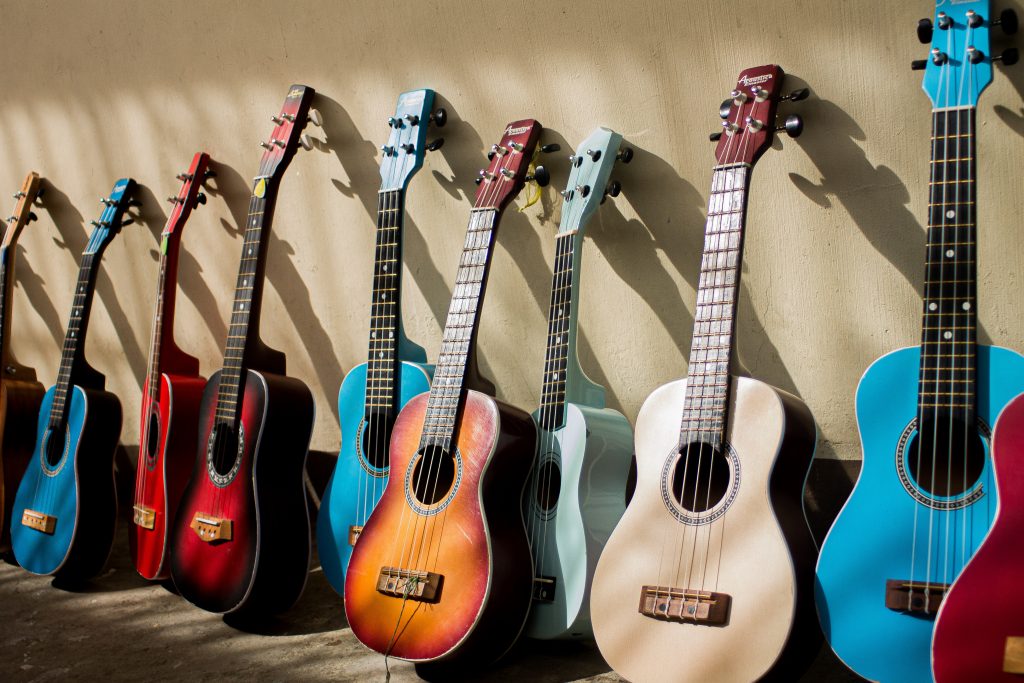 different guitars leaning against the wall