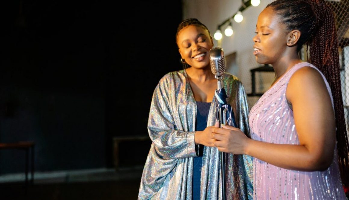 two women singing at a concert
