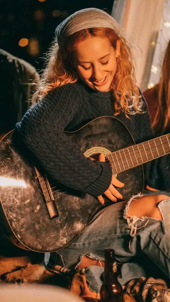 girl singing and playing guitar